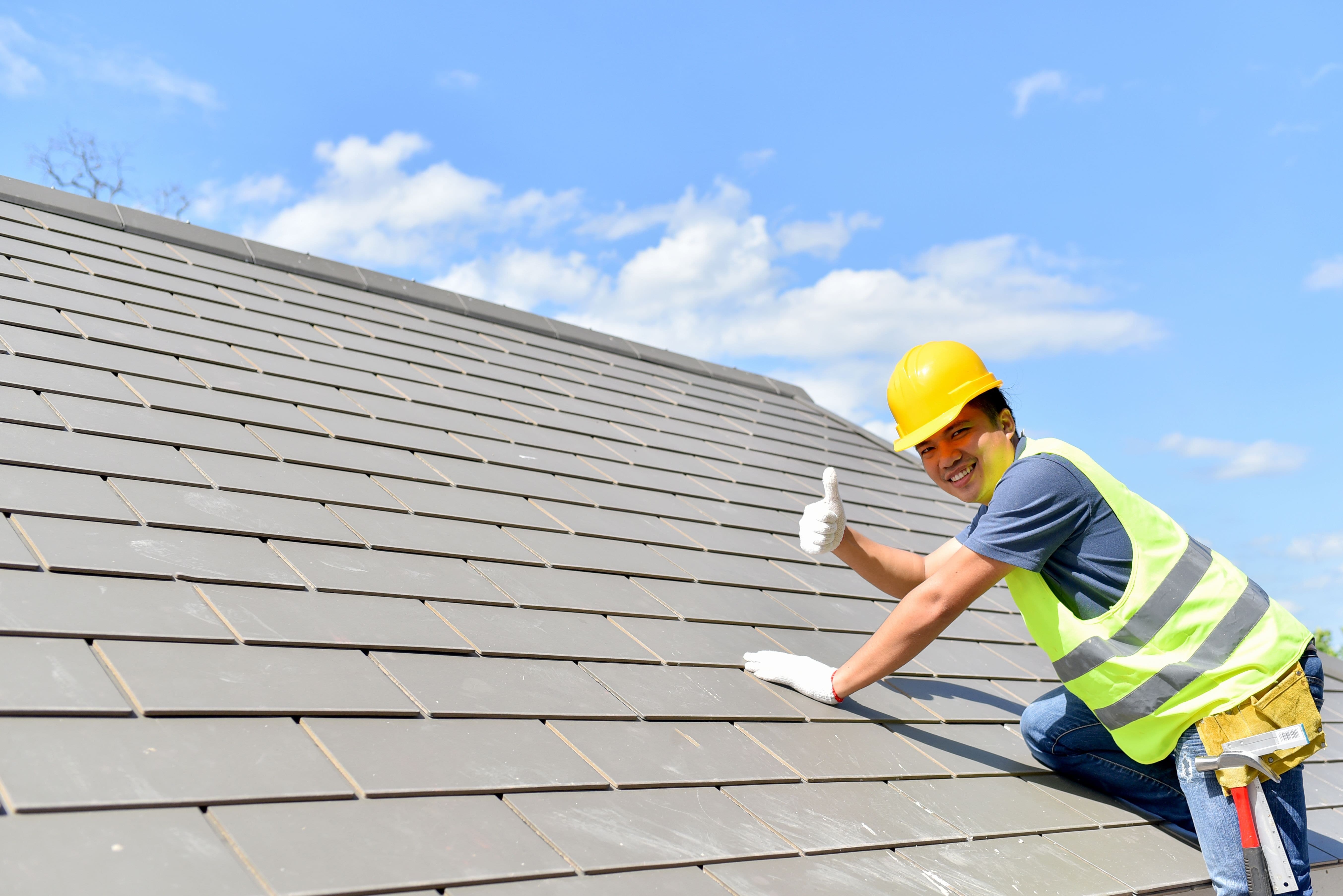 Man Showing Thumbs Up After Fixing Roof